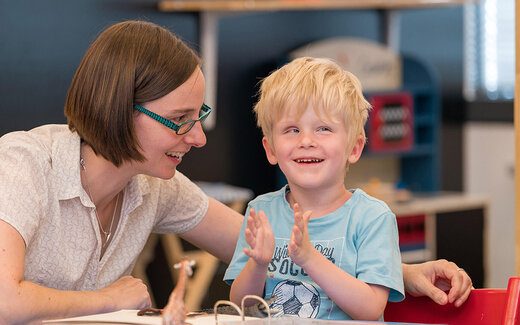 Kind und Frau spielen gemeinsam in der Stiftung St. Franziskus